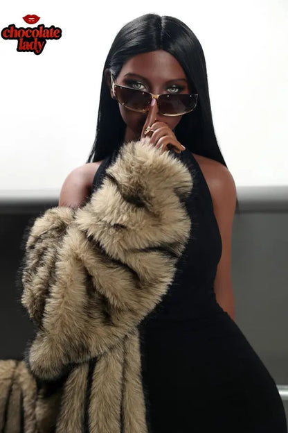 Ebony doll wearing red tights and black top