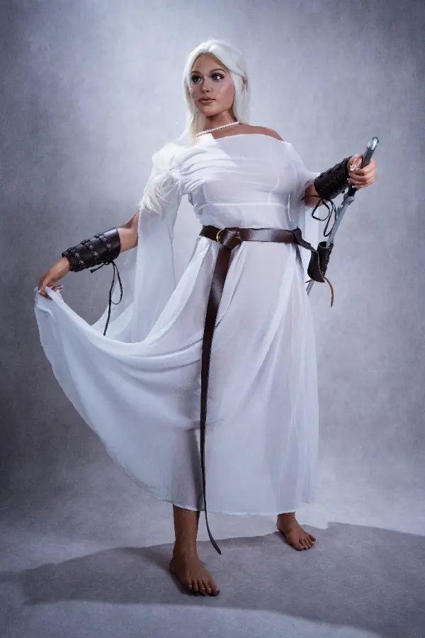 Full body pose of Selena holding a knightly sword in a white gown.
