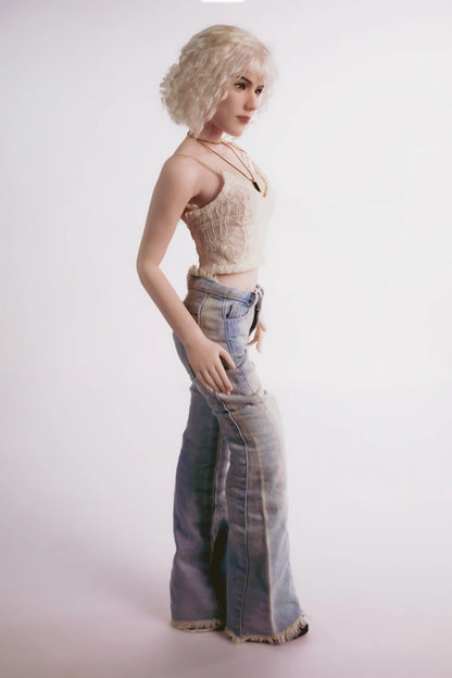 Close-up of Blonde Fashion Doll face, highlighting Full Silicone and confident look.